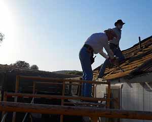 Bernice and Gene Working on the Roof at Sunup