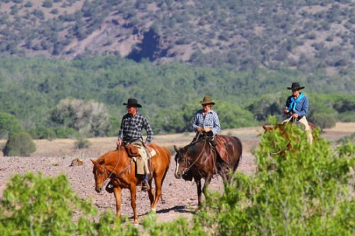 Ranch Guests Ebba, Inger and Jorge Riding Horses Out to the Herd